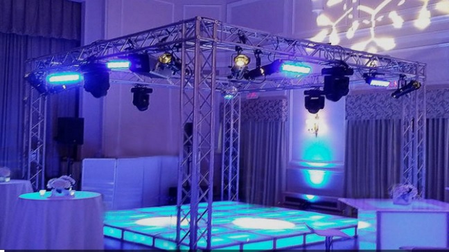 Locação de Equipamentos, pista de dança com estrutura, iluminação ao redor da pista, montagem compacta para salão, pontos de luz distribuídos, efeito visual para entrada, iluminação que valoriza fotos, destaque para área central, estrutura para animar a festa, montagem alinhada e nivelada, solução para pista organizada, quadro iluminado para dança, efeito de luz contínua, suporte técnico na instalação, área de dança bem marcada, cenário para pista de festa, aluguel de estrutura para eventos